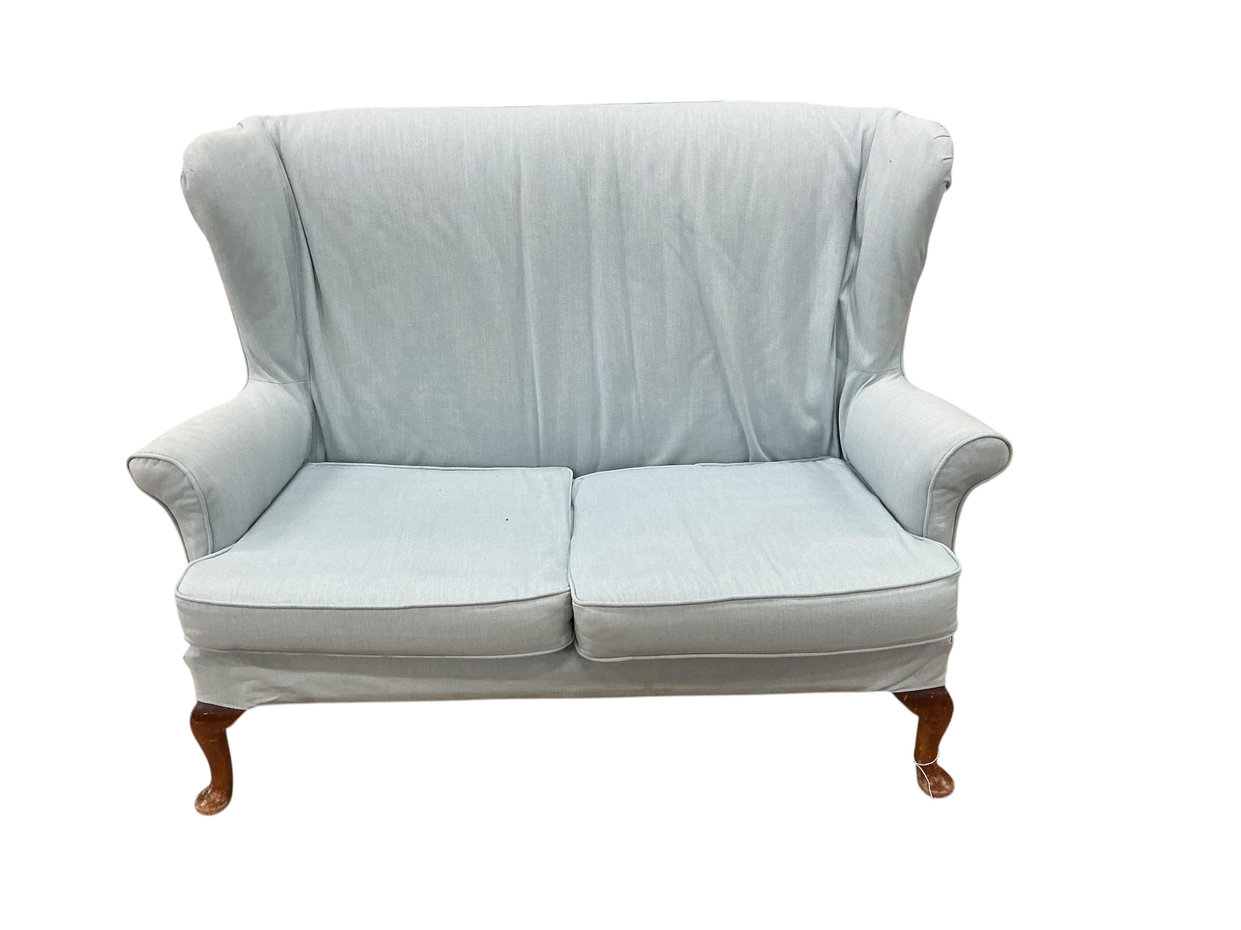 A Parker Knoll wing back upholstered two seater settee, width 136cm, depth 70cm, height 96cm